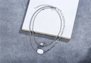 Close-up of double layer titanium steel necklace with Believe engraved oval tag pendant