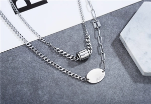 Detail of silver double layered stainless steel necklace with engraved tags and chains