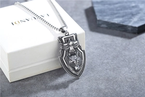 Detail shot of vintage shield pendant with eagle and wolf head relief in steel