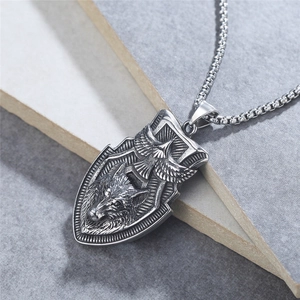 Vintage stainless steel shield necklace featuring embossed wolf and eagle totem design
