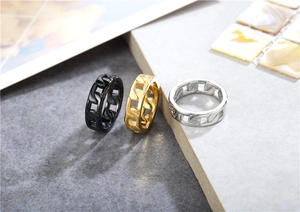 Close-up of Cuban link rings in matte black, polished gold and silver finishes