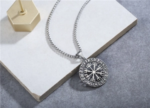 Close-up of Viking compass pendant with Elder Futhark runes on steel square pearl chain