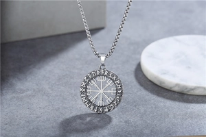 Detailed close-up of Vegvisir Viking compass pendant with Elder Futhark runes engraving