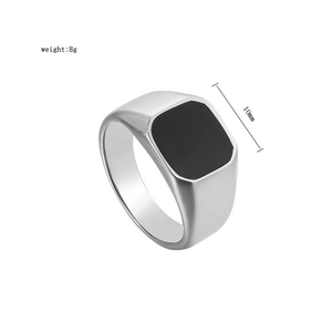 Detail of 10mm wide square black enamel signet ring in polished stainless steel for men