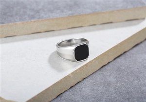 Close-up of square silver steel ring for men with black enamel inlay on stone
