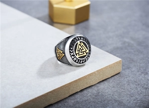 Macro detail of Nordic Viking Valknut ring with Elder Futhark runes and sunburst texture