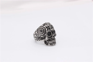 Détail de la bague tête de mort mexicaine avec motifs solaires et yeux en gemmes noires