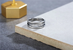 Macro shot of layered steel wire ring with retro vintage finish on stone surface