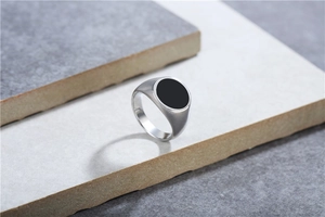 Macro detail of silver titanium steel ring with round black dripping oil inlay texture