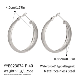 Detailed view of thick silver-tone stainless steel hoop earrings with high polish finish
