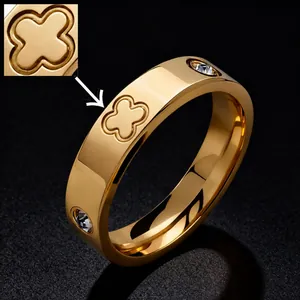 Macro detail of gold-plated titanium ring with inlaid diamonds and clover design