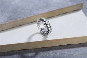 Macro shot of vintage silver steel ring featuring skeletal lizard bone punk design
