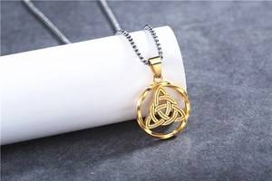 Macro shot of the Celtic Triquetra pendant on a silver box chain with vintage finish
