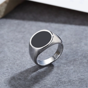 Minimalist silver steel signet ring with oval black enamel top on grey stone