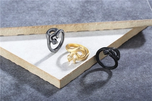 Detailed snake-shaped rings with realistic scale texture in silver, gold, and matte black