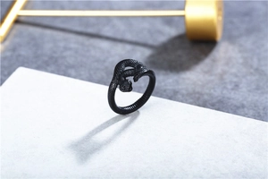 Close-up of matte black snake ring showing detailed scales and vintage coiled design