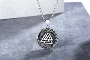 Macro detail of Nordic Viking Valknut pendant with antique silver finish on steel chain