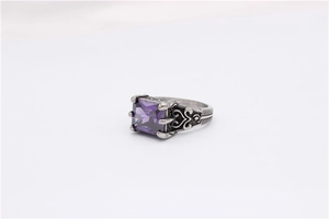 Macro detail of gothic silver steel ring featuring square purple zircon and filigree