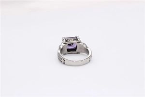 Detailed close-up of vintage steel ring featuring a purple rectangular gemstone