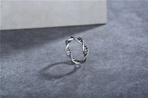 Detailed macro view of vintage silver DNA double helix ring with black oxidized finish