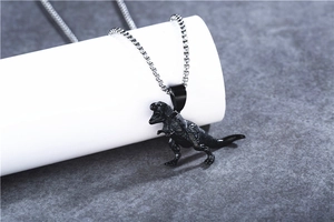Close-up of black T-Rex dinosaur pendant with detailed texture on silver box chain