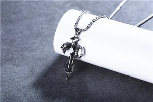 Detailed shot of retro stainless steel dagger pendant with snake carving and zircon