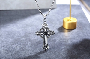 Detailed close-up of Gothic Celtic cross pendant with black zircon and fleur-de-lis engravings