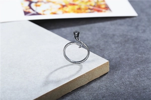Macro shot of retro cobra snake ring with realistic scale texture and oxidized finish