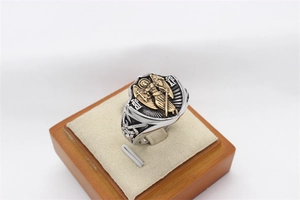 Gros plan sur le bouclier d'aile d'ange vintage et détails gravés sur la bague en acier