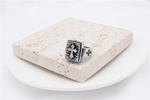 Close-up of vintage titanium steel ring with embossed cross and engraved text details