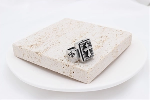 Macro detail of vintage silver titanium steel ring with embossed cross design