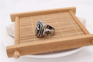 Detail view of retro men's steel ring with cross relief and engraved GOD text on top