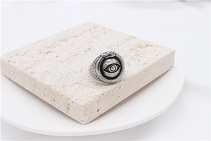 Detail shot of vintage silver Eye of Providence ring with snake textures on stone stand
