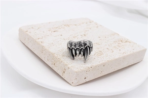 Macro detail of retro stainless steel beast claw ring showing brushed metal texture and aged finish