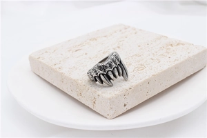 Macro shot of vintage monster jaw and teeth design on a heavy titanium steel men's ring