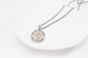 Detail of silver box chain with St. Jude Thaddeus gold-tone embossed religious pendant