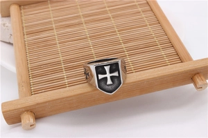 Macro shot of vintage cross shield signet ring showing the antique finish detail