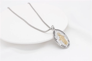 Macro detail of oval St. Jude Thaddeus prayer pendant on stainless steel box chain