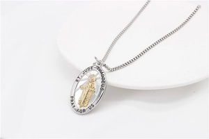 Detail of St. Jude Thaddeus gold and silver pendant with religious engraving and box chain