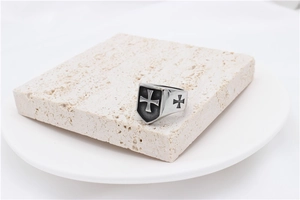 Detail of vintage gothic cross ring for men with shield shape on stone pedestal