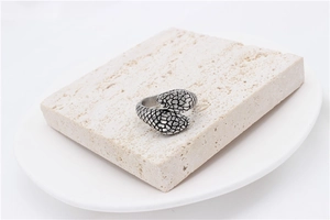 Close-up of vintage snake scale texture on a bypass style titanium steel ring