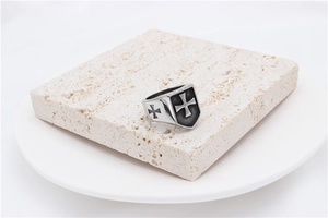 Close-up of vintage rock style cross shield ring for men in antique finish steel