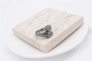 Macro detail of snake-shaped wrap ring showing intricate vintage scale textures