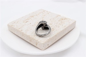 Detailed macro view showing the intricate snake scales on this vintage steel ring