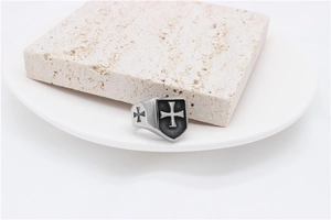 Macro detail of men's vintage steel ring with cross emblem on a shield-shaped face