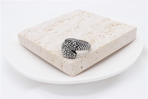 Macro detail of retro snake scale pattern on a vintage silver titanium steel ring
