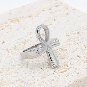 Polished stainless steel Egyptian Ankh ring on stone background for men and women