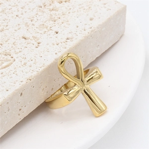 Polished gold Egyptian Ankh cross stainless steel ring displayed on natural stone