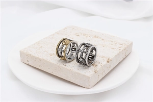Close-up of retro hollow crown rings with gothic cross pattern in silver and gold finish