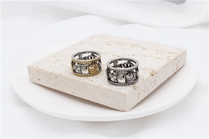 Detailed macro view of vintage hollowed crown and cross relief on retro steel rings